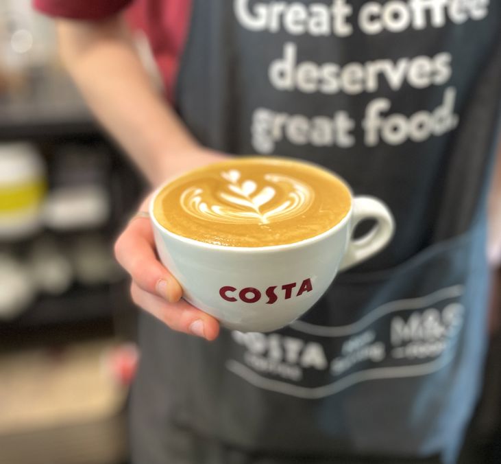 One Costa Barista Holding Flat White Square